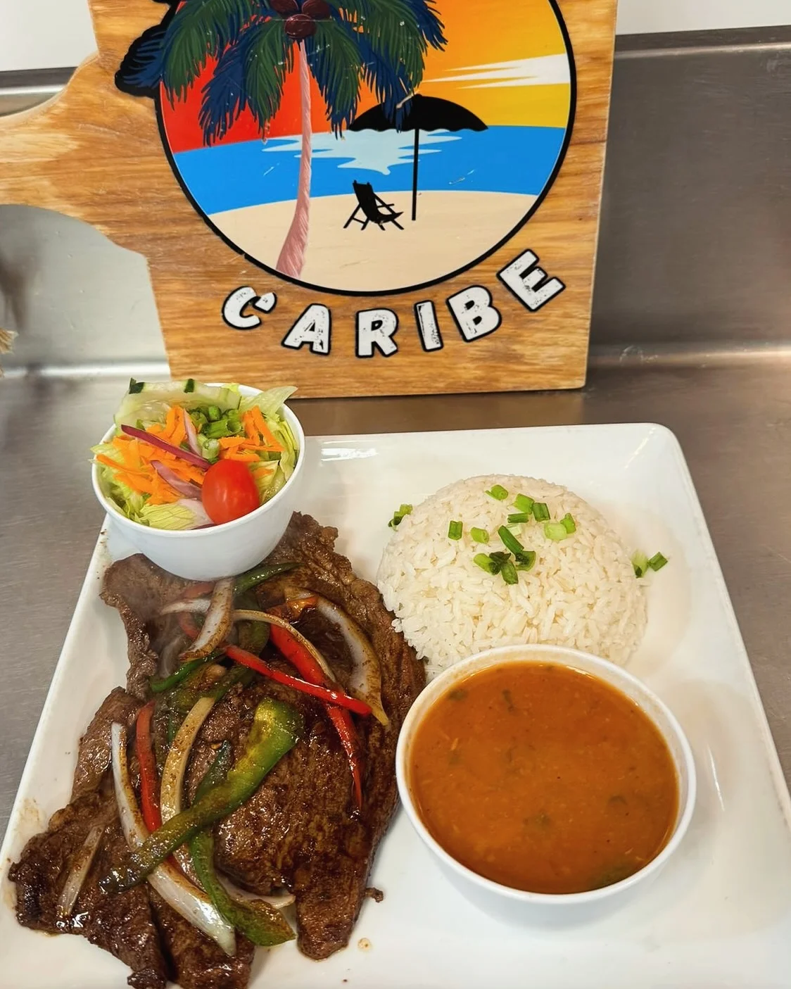 Steak with white rice, beans, and side salad at Caribe